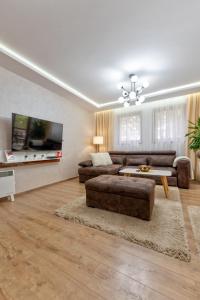 a living room with a couch and a table at Apartman Gačanović Lux in Zlatibor