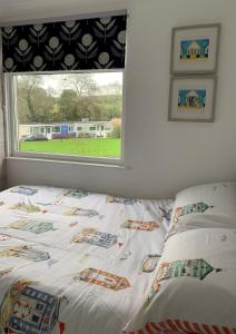 a bed in a bedroom with a window at Chalet 80 in Sandown