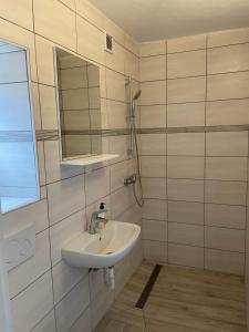 a bathroom with a sink and a mirror at Apartmaji Sara, Izola - Isola in Izola