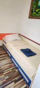 a bed with a blue shirt sitting on top of it at Inessa center budget room in Chişinău