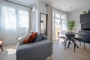 a living room with a couch and a table at Renovated Studio walking distance to Paris in Montrouge
