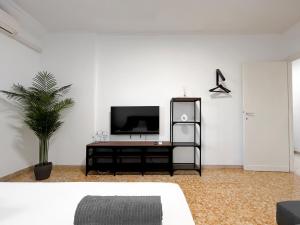 a living room with a tv on a white wall at Horizon - Concept Apartment in Rome