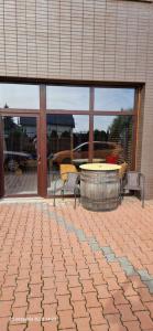 a patio with a table and chairs and a table and windows at WILLA VASCO ADMIRAŁ in Rewa
