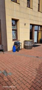 a picnic table and a barrel in front of a building at WILLA VASCO ADMIRAŁ in Rewa