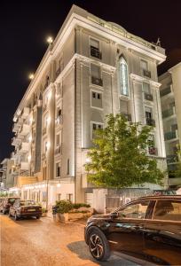 a car parked in front of a building at night at Hotel Augustus in Rimini