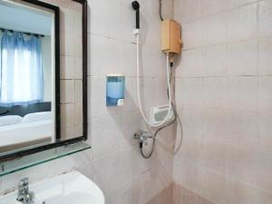 a shower in a bathroom with a sink and a mirror at Amrise Hotel, Check in at 10PM, Check out at 9AM in Singapore +20 photos