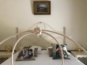 a white bed with a white canopy with pillows at Villa la Vista in Lumio