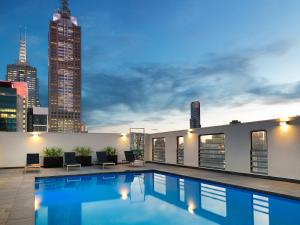 a swimming pool on the roof of a building at Hotel Grand Chancellor Melbourne in Melbourne