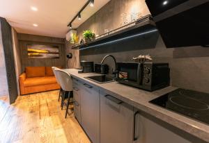 a kitchen with a sink and a counter top at Apartments DREAM in Málaga