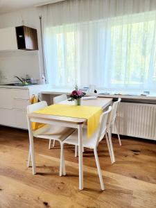 a kitchen with a table with a yellow table cloth on it at Apartment Sonnenschein in Dornbirn