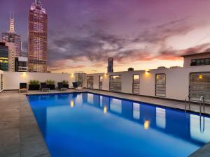 
a large swimming pool with a blue sky at Hotel Grand Chancellor Melbourne in Melbourne
