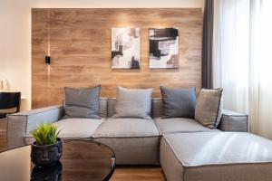 a living room with a couch and a table at Good times - Luxury Studio Apartments in Xanthi