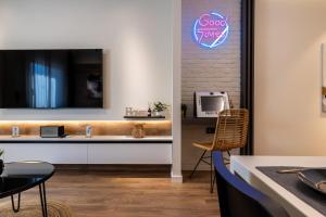 a room with a desk and a tv on a wall at Good times - Luxury Studio Apartments in Xanthi