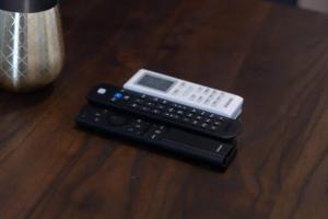 a remote control and a calculator sitting on a table at Exec. Studio @Embassy Gardens in Cantonments