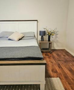 a bedroom with a bed and a table with a lamp at Forest Trails House, Dwellingup in Dwellingup
