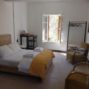 a bedroom with a bed and a chair and a window at Sabor Residence in North Nicosia