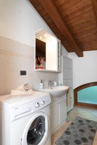 a bathroom with a washing machine and a sink at Maison Château - Vista Castello di Saint Pierre in Saint-Pierre