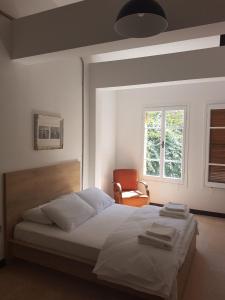 a bedroom with a bed with a chair and a window at Sabor Residence in North Nicosia