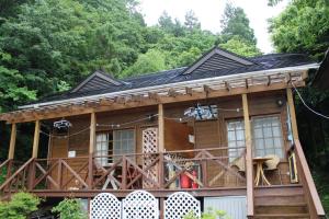 a tree house with a wrap around deck at Sun Lake in Fujikawaguchiko