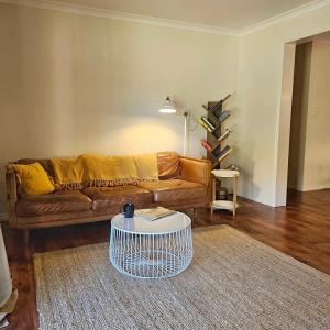 a living room with a couch and a coffee table at Forest Trails House, Dwellingup in Dwellingup