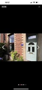 a picture of a white door with a brick building at Luxury Belfast Stay - Townhouse in Belfast