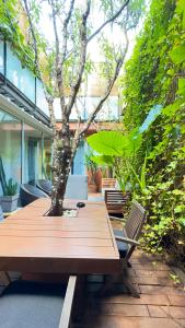 a wooden table with a tree in the middle at ArtlifeBCN Urban Oasis Apartment in Barcelona
