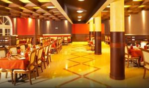 a restaurant with tables and chairs in a room at Hotel Luciya Palace in Trichūr