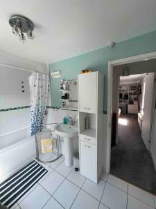 a small bathroom with a sink and a toilet at Private Flat in City Centre with Parking in Southampton