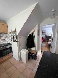 a kitchen with a stairway with a clothes rack at Private Flat in City Centre with Parking in Southampton