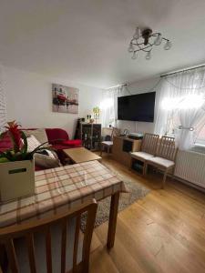 a living room with a couch and a tv at Private Flat in City Centre with Parking in Southampton