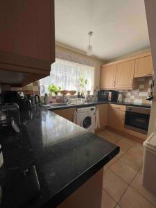 a kitchen with a black counter top and a stove at Private Flat in City Centre with Parking in Southampton