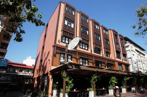 a building with a clock on the side of it at Rambuttri Village Plaza in Bangkok