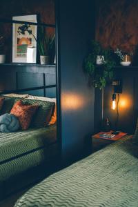 ein blaues Schlafzimmer mit einem Bett und einem Spiegel in der Unterkunft The Longsands Home- Coastal Retreat with Hot Tub in Cullercoats