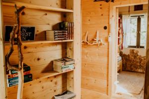 a log cabin with a book shelf and books at Prawie na końcu drogi in Rabka-Zdroj +18 photos