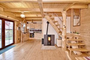 a log cabin with a spiral staircase in a living room at Prawie na końcu drogi in Rabka-Zdroj