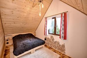 a bedroom with a bed in a attic at Prawie na końcu drogi in Rabka-Zdroj