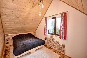 a bedroom with a bed in a attic at Prawie na końcu drogi in Skomielna Biała