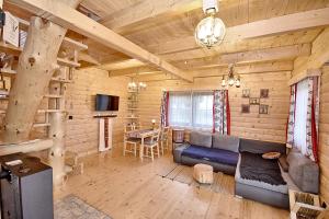 a living room with a blue couch in a log cabin at Prawie na końcu drogi in Rabka-Zdroj