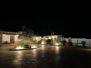 un patio por la noche con una fuente en el medio en Vivienda Rural El Chirimbolo, en Conil de la Frontera