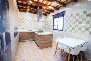 a kitchen with a table and a sink and a table at Vivienda Rural El Chirimbolo in Conil de la Frontera