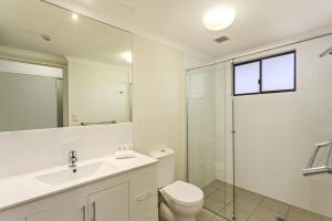 a bathroom with a toilet and a sink and a shower at Aligned Corporate Residences Townsville in Townsville