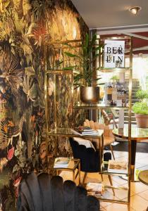 a room with a wall covered in plants at Hotel Carolinenhof in Berlin