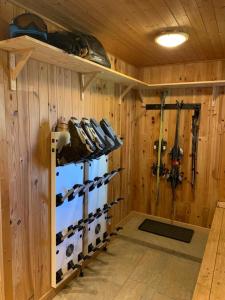 a room with a rack of shoes in a wooden wall at Chalet Les Erines in Châtel