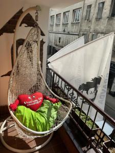 a basket with a red heart on it on a balcony at Hostel Scandic in Sarajevo