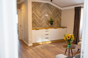 a kitchen with a counter and a vase of flowers on a table at B59 BOUTIQUE HOTEL in Câmpulung Moldovenesc