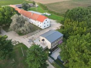 an overhead view of a large white building with a red roof at Penzion NoFasada in Bzenec