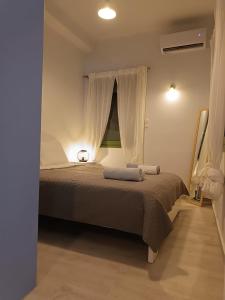 a bedroom with a large bed with a window at Sigma Acropolis GF in Athens