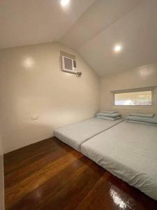 a bedroom with two beds and a window at Luxury Tiny Home with Free* Use of Tiny Car in El Nido