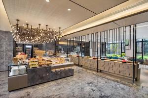 a restaurant with a buffet line of food at Courtyard by Marriott Hangzhou West in Hangzhou
