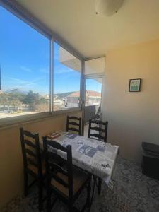 a dining room with a table and chairs and a window at Studio très agréable avec balcon et Wi-Fi in Sanary-sur-Mer